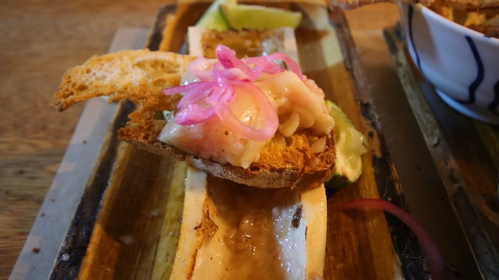 tuétano asado con tostas y cebolla encurtida
